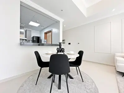 a dining room with a table and chairs and a mirror at Luxury Stay in Downtown Dubai -Burj Khalifa in Dubai