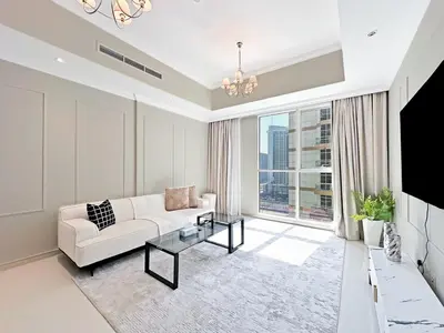 a living room with a white couch and a large window at Luxury Stay in Downtown Dubai -Burj Khalifa in Dubai