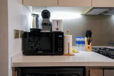 a microwave sitting on top of a kitchen counter at EasyGo - Bright Studios in The Heart of Business Bay in Dubai