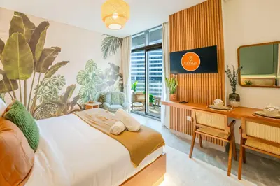 a bedroom with a bed and a desk and a television at EasyGo - Bright Studios in The Heart of Business Bay in Dubai