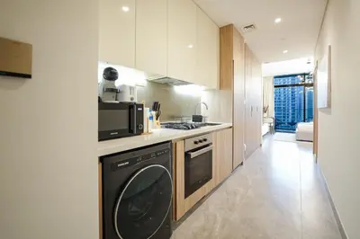 a kitchen with a washer and dryer in it at EasyGo - Bright Studios in The Heart of Business Bay in Dubai