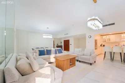 a living room with white furniture and a dining room at 4BR Spacious Apartment in Sadaf 8 JBR, 3 Min Walk To The Beach With Sea and Dubai Marina View in Dubai