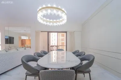 a dining room with a white table and chairs at 4BR Spacious Apartment in Sadaf 8 JBR, 3 Min Walk To The Beach With Sea and Dubai Marina View in Dubai