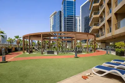 a gazebo on a lawn in front of a building at Studio for 4 just 5 Min Walk to Burj Khalifa, Downtown Dubai, Tower Elite 1 in Dubai