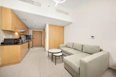 a living room with a couch and a table at FIRST CLASS High End Studio near Miracle Garden in Dubai