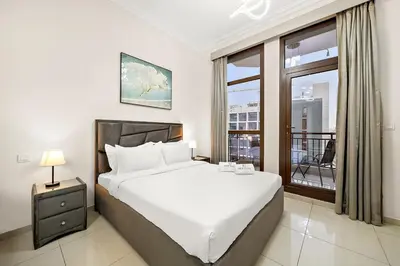 a bedroom with a large bed and a window at FIRST CLASS High End Studio near Miracle Garden in Dubai