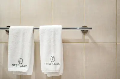 three towels on a towel rack in a bathroom at FIRST CLASS High End Studio near Miracle Garden in Dubai
