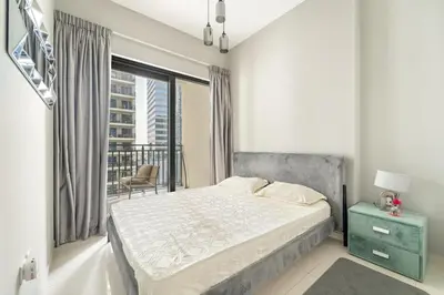a bedroom with a bed and a balcony at Stylish 1BR w/ Pool View | Heart of Business Bay in Dubai