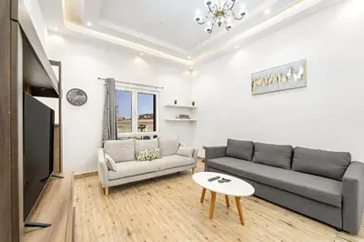 a living room with a couch and a table at FIRST CLASS 1BR Stylish Escape , Near Metro in Dubai
