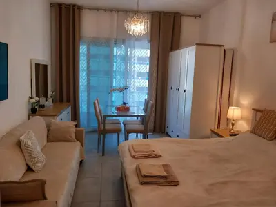 a living room with a bed and a table with a couch at Dubai Marina Apartment in Dubai