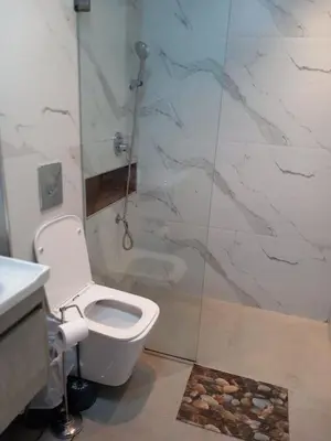 a bathroom with a toilet and a shower at Dubai Marina Apartment in Dubai