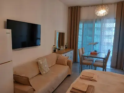 a living room with a couch and a table at Dubai Marina Apartment in Dubai