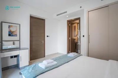 a bedroom with a large bed with towels on it at Blue Breeze - Luxury 2BR in Sobha Creek Vistas Near Downtown in Dubai