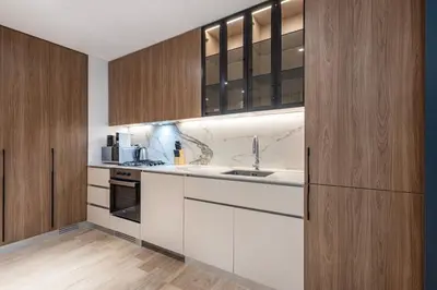 a kitchen with white cabinets and a sink at Hamilton House, JVC - 1 Bedroom Apartment - Allsopp & Allsopp in Dubai