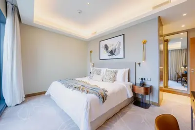 a bedroom with a large white bed in a room at Address Dubai Opera Residence with Burj Khalifa Views in Dubai