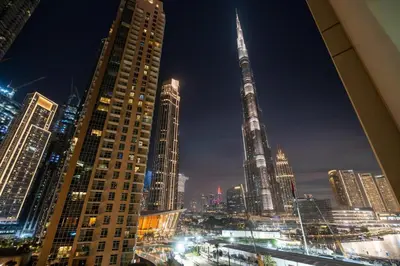 a view of a city at night with tall buildings at GuestReady - Stunning Burj View | Near Dubai Mall in Dubai