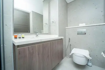a bathroom with a sink and a toilet and a mirror at AWS Holiday Homes - Modernity with a View in Dubai