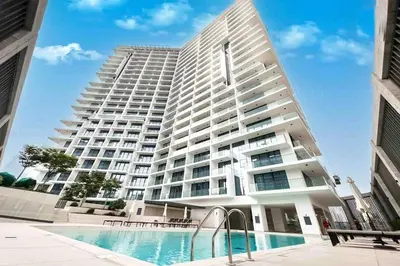 a large building with a swimming pool in front of it at AWS Holiday Homes - Modernity with a View in Dubai