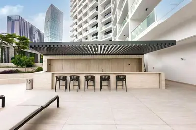 a patio with chairs and a bar in a building at AWS Holiday Homes - Modernity with a View in Dubai