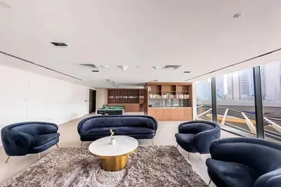 a living room with couches and a pool table at AWS Holiday Homes - Modernity with a View in Dubai