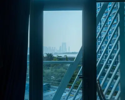 a view from the window of a building at Chic Studio with Beach & Rooftop Pool Access in Dubai