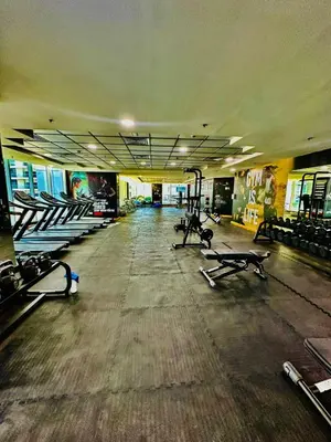 an empty gym with rows of treadmills and machines at COZY 1BD in Dubai Marina in Dubai