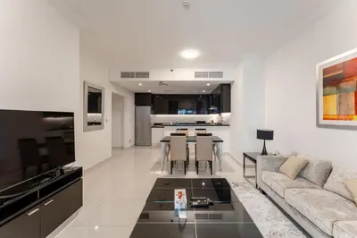 a living room with a couch and a table at Elegant Business Bay 2 Bedroom with Sauna, Pool and Jacuzzi in Dubai