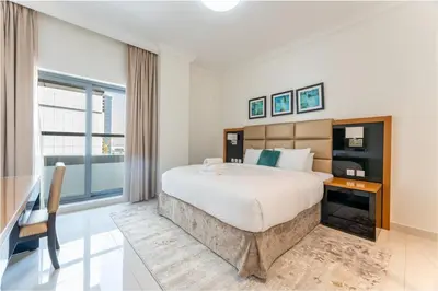 a bedroom with a large bed and a large window at Elegant Business Bay 2 Bedroom with Sauna, Pool and Jacuzzi in Dubai