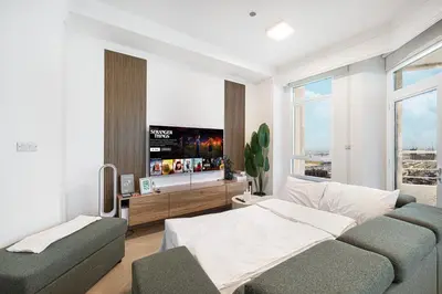 a living room with a couch and a tv at Amazing Palm View - Prime Location - Spacious in Dubai