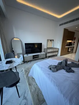 a bedroom with a large bed and a television at DiSalvo Luxury Studio in Azizi riviera 67 in Dubai