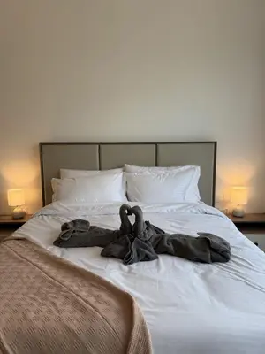 a blanket is laying on top of a bed at DiSalvo Luxury Studio in Azizi riviera 67 in Dubai
