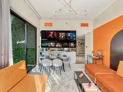 a living room with a couch and a table at Binghatti Canal 2 Bedroom Suite with Burj Khalifa View, Spacious Balcony, and Infinity Pool in Dubai