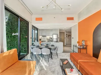 a living room with a couch and a table at Binghatti Canal 2 Bedroom Suite with Burj Khalifa View, Spacious Balcony, and Infinity Pool in Dubai