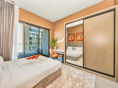 a bedroom with a bed and a large window at Binghatti Canal 2 Bedroom Suite with Burj Khalifa View, Spacious Balcony, and Infinity Pool in Dubai