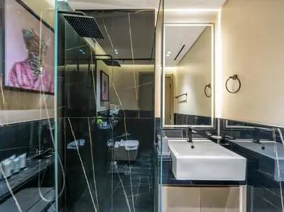 a bathroom with a sink and a mirror at Binghatti Canal 2 Bedroom Suite with Burj Khalifa View, Spacious Balcony, and Infinity Pool in Dubai
