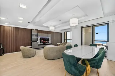a dining room with a table and chairs and a fireplace at 3 Bed Spacious JBR Modern Living Holiday Home in Dubai