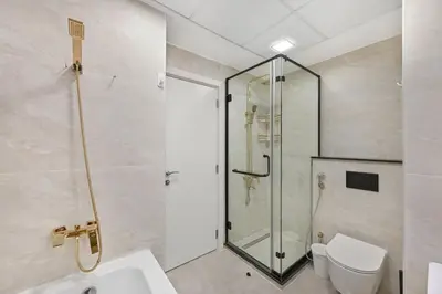 a bathroom with a glass shower and a toilet at 3 Bed Spacious JBR Modern Living Holiday Home in Dubai