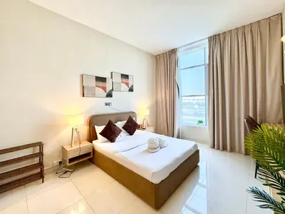 a hotel room with a bed and a large window at Signature Horizon Studio with Boulevard Views in Dubai