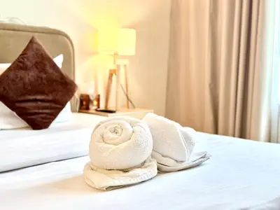 a hotel room with towels on a bed at Signature Horizon Studio with Boulevard Views in Dubai