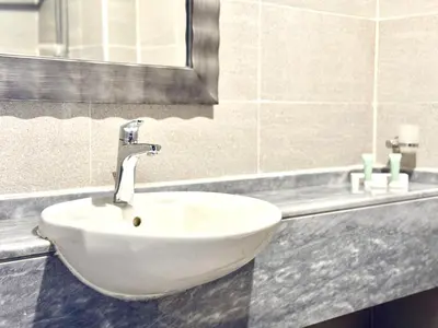 a white sink in a bathroom with a mirror at Signature Horizon Studio with Boulevard Views in Dubai