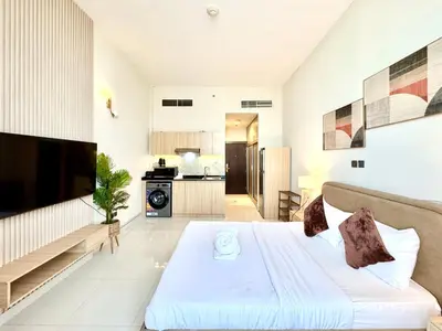 a living room with a bed and a kitchen at Signature Horizon Studio with Boulevard Views in Dubai
