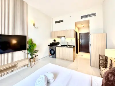a living room with a couch and a stove at Signature Horizon Studio with Boulevard Views in Dubai