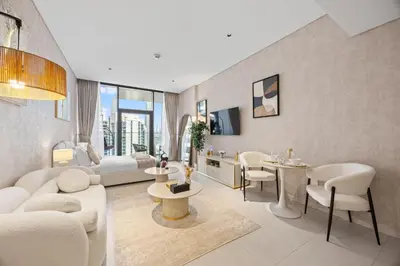 a living room with a couch and a table at Burj Khalifa View Premium Studio near Dubai Mall in Dubai