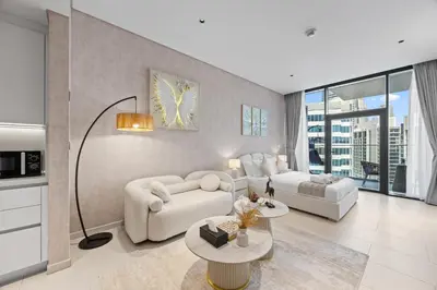 a living room with two couches and a table at Burj Khalifa View Premium Studio near Dubai Mall in Dubai