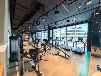 a gym with several treadmills and cardio machines at Burj Khalifa View Premium Studio near Dubai Mall in Dubai