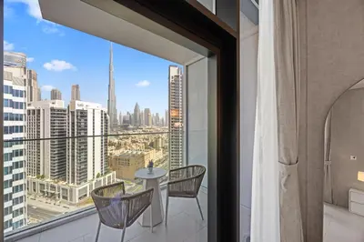 a balcony with a table and chairs and a view of the city at Burj Khalifa View Premium Studio near Dubai Mall in Dubai