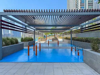 a pool with blue water in a building at Bright 2BR APT Near The Burj Khalifa and Dubai Mall in Dubai