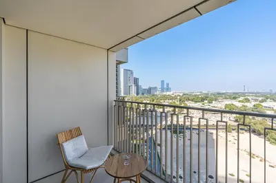 a balcony with a chair and a table and a view at Bright 2BR APT Near The Burj Khalifa and Dubai Mall in Dubai