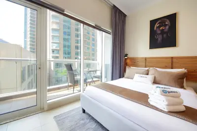 a bedroom with a bed and a large window at HiGuests - Chic Studio in Downtown Dubai in Dubai