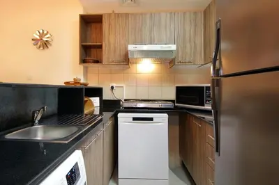 a kitchen with a sink and a refrigerator at HiGuests - Chic Studio in Downtown Dubai in Dubai